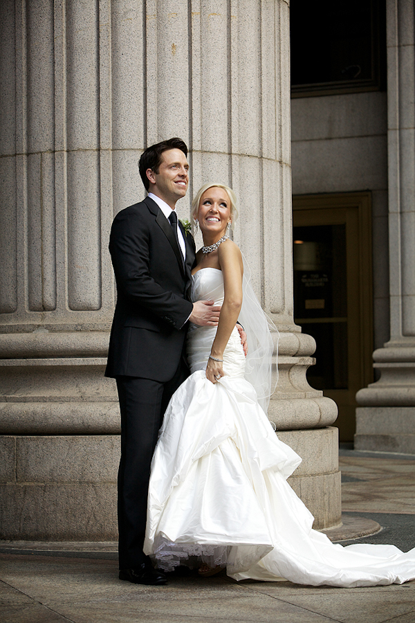 bride and groom together by a column - wedding photo by top Philadelphia based wedding photographers Langdon Photography